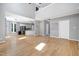 Spacious living room featuring wood floors and an open floor plan into the kitchen at 917 Haddon Hall Dr, Apex, NC 27502