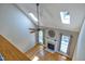 Open living room with hardwood floors, fireplace, and large windows at 917 Haddon Hall Dr, Apex, NC 27502