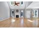 Spacious living room featuring hardwood floors, fireplace, and large windows for natural light at 917 Haddon Hall Dr, Apex, NC 27502