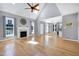Open-concept living room features fireplace, wood floors, and seamless access to other living spaces at 917 Haddon Hall Dr, Apex, NC 27502
