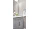 Chic powder room featuring a gray vanity, marble countertop, and modern fixtures at 917 Haddon Hall Dr, Apex, NC 27502