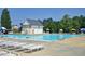 Large community swimming pool with sun loungers and umbrellas at 917 Haddon Hall Dr, Apex, NC 27502