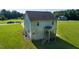 Spacious backyard featuring a two-story home with a charming porch and ample green space at 933 Weatherby Ln, Creedmoor, NC 27522