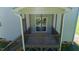 Enclosed back porch with wooden railings offering a private outdoor space at 933 Weatherby Ln, Creedmoor, NC 27522