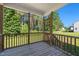 A relaxing screened-in porch offering views of the lush backyard and surrounding greenery at 933 Weatherby Ln, Creedmoor, NC 27522