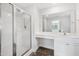 Bright bathroom with shower, vanity, and large mirror at 933 Weatherby Ln, Creedmoor, NC 27522