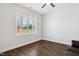 This empty bedroom has hardwood floors and a large window that lets in natural light at 933 Weatherby Ln, Creedmoor, NC 27522