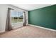 Empty bedroom with carpet, window, and grey curtains at 933 Weatherby Ln, Creedmoor, NC 27522