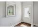 A modest entryway is decorated with a framed mirror, and a frosted glass door at 933 Weatherby Ln, Creedmoor, NC 27522