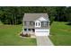 Charming two-story home with well-maintained lawn, complemented by a spacious driveway at 933 Weatherby Ln, Creedmoor, NC 27522