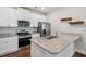 Bright kitchen featuring stainless steel appliances, granite countertops, and ample storage space at 933 Weatherby Ln, Creedmoor, NC 27522