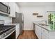 Bright modern kitchen featuring stainless steel appliances, granite countertops, and plenty of countertop space at 933 Weatherby Ln, Creedmoor, NC 27522