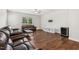 Comfortable living room with hardwood floors, featuring large window and leather seating at 933 Weatherby Ln, Creedmoor, NC 27522