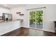 Open-concept living room showcasing access to the kitchen, a porch, and hardwood floors at 933 Weatherby Ln, Creedmoor, NC 27522