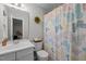 Well-lit bathroom featuring a vanity, toilet, and a shower with a colorful butterfly-themed curtain at 100 Redfoot Run Rd, Chapel Hill, NC 27516