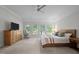 Bright bedroom featuring a large bed, dresser, and rocking chair at 100 Redfoot Run Rd, Chapel Hill, NC 27516