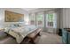 Sunlit bedroom with large windows, neutral decor, and comfortable furnishings at 100 Redfoot Run Rd, Chapel Hill, NC 27516