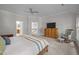 Bright bedroom featuring a large bed, dresser, and rocking chair at 100 Redfoot Run Rd, Chapel Hill, NC 27516