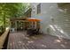 Spacious wooden deck with outdoor furniture, umbrella, and views of backyard at 100 Redfoot Run Rd, Chapel Hill, NC 27516