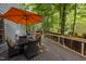 Inviting outdoor deck with dining table and grill, perfect for entertaining at 100 Redfoot Run Rd, Chapel Hill, NC 27516