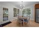 Cozy dining area with natural light, a modern light fixture, and seating for four at 100 Redfoot Run Rd, Chapel Hill, NC 27516