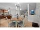 Open dining area connecting to the kitchen and living room with a modern light fixture and round table at 100 Redfoot Run Rd, Chapel Hill, NC 27516