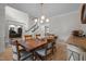 Elegant dining room featuring a large table, decorative lighting, and staircase at 100 Redfoot Run Rd, Chapel Hill, NC 27516