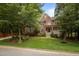 Beautiful brick two-story home with landscaped front yard and mature trees at 100 Redfoot Run Rd, Chapel Hill, NC 27516
