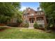 Charming brick two-story home with landscaped yard and white trim at 100 Redfoot Run Rd, Chapel Hill, NC 27516