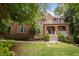 Gorgeous brick two-story home with landscaped front yard and covered porch at 100 Redfoot Run Rd, Chapel Hill, NC 27516
