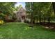 Attractive two-story home with lush green lawn and mature trees offering shade and privacy at 100 Redfoot Run Rd, Chapel Hill, NC 27516