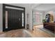 Welcoming foyer showcasing beautiful hardwood floors and front door view of the outdoors at 100 Redfoot Run Rd, Chapel Hill, NC 27516