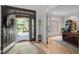 Welcoming foyer showcasing beautiful hardwood floors and front door view of the outdoors at 100 Redfoot Run Rd, Chapel Hill, NC 27516