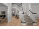 Bright foyer featuring a grand staircase, hardwood floors, and a glimpse of the living room at 100 Redfoot Run Rd, Chapel Hill, NC 27516