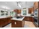 Well-equipped kitchen with an island, stainless steel appliances, custom cabinets, and ample counter space at 100 Redfoot Run Rd, Chapel Hill, NC 27516