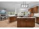 Open concept kitchen with an island, hardwood floors, modern appliances and seamless access to living spaces at 100 Redfoot Run Rd, Chapel Hill, NC 27516