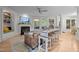 Bright living room featuring a fireplace, large windows, hardwood floors, and stylish seating area at 100 Redfoot Run Rd, Chapel Hill, NC 27516
