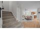 Inviting staircase leading to a spacious living room with hardwood floors at 100 Redfoot Run Rd, Chapel Hill, NC 27516