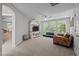 Comfortable living room with a TV, modern furnishings, and natural light from three large windows at 100 Redfoot Run Rd, Chapel Hill, NC 27516