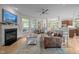 Comfortable living room with a fireplace, hardwood floors, large windows, and ample seating space at 100 Redfoot Run Rd, Chapel Hill, NC 27516