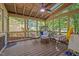 Inviting screened porch with comfortable seating, wood ceiling, and views of the surrounding greenery at 100 Redfoot Run Rd, Chapel Hill, NC 27516