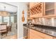 Entertainers bar area with custom cabinets, granite counters, and wine refrigerator at 101 Lochmere Forest Dr, Cary, NC 27518