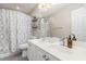 A well-lit bathroom with double vanity sinks and decorative shower curtain at 101 Lochmere Forest Dr, Cary, NC 27518