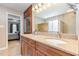 Bathroom with granite countertops, double sinks, wood cabinets, and walk-in shower at 101 Lochmere Forest Dr, Cary, NC 27518