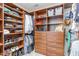 Walk in closet with custom shelving and built-in wooden drawers at 101 Lochmere Forest Dr, Cary, NC 27518