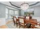 Elegant dining room featuring a chandelier, bay window and neutral colored walls at 101 Lochmere Forest Dr, Cary, NC 27518