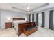 A serene main bedroom with a tray ceiling, dark wood furniture, and plenty of natural light at 101 Lochmere Forest Dr, Cary, NC 27518