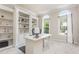Bright office featuring custom built-ins, arched windows, and neutral carpet at 101 Lochmere Forest Dr, Cary, NC 27518