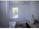 Bathroom features a tub, toilet, sink, vanity, and window at 103 Sara Dr, Nashville, NC 27856