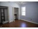 Bedroom with two closets, hardwood floors, a window, and base trim at 103 Sara Dr, Nashville, NC 27856